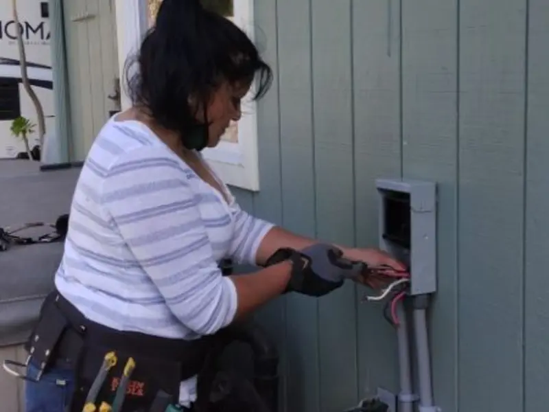 Licensed electrician wiring an exterior subpanel in Nevada City
